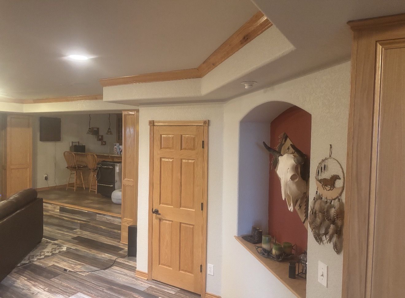 Basement hallway with an arched niche painted terracotta
